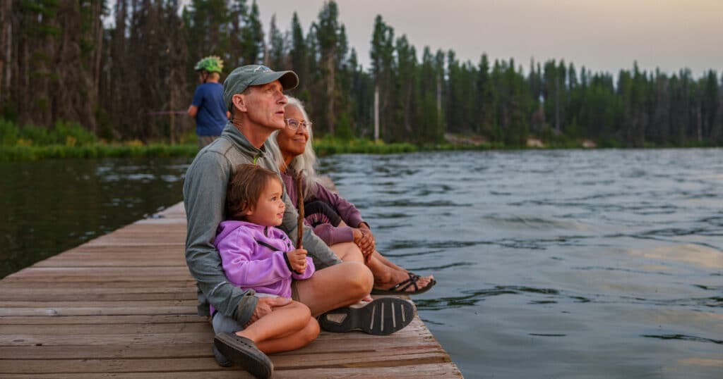 Elderly couple and grandchild look off into the sunset with peace of mind that comes from their understanding of intestate succession in California.