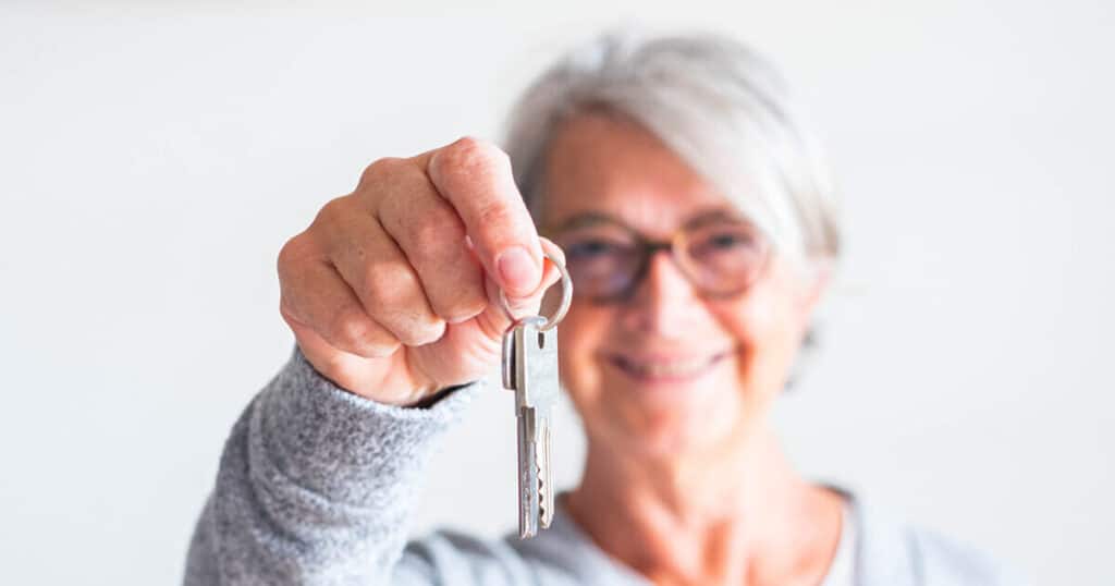 An elderly woman gifting her home to her son understands the implications of lifetime gifting on CA inheritance tax.