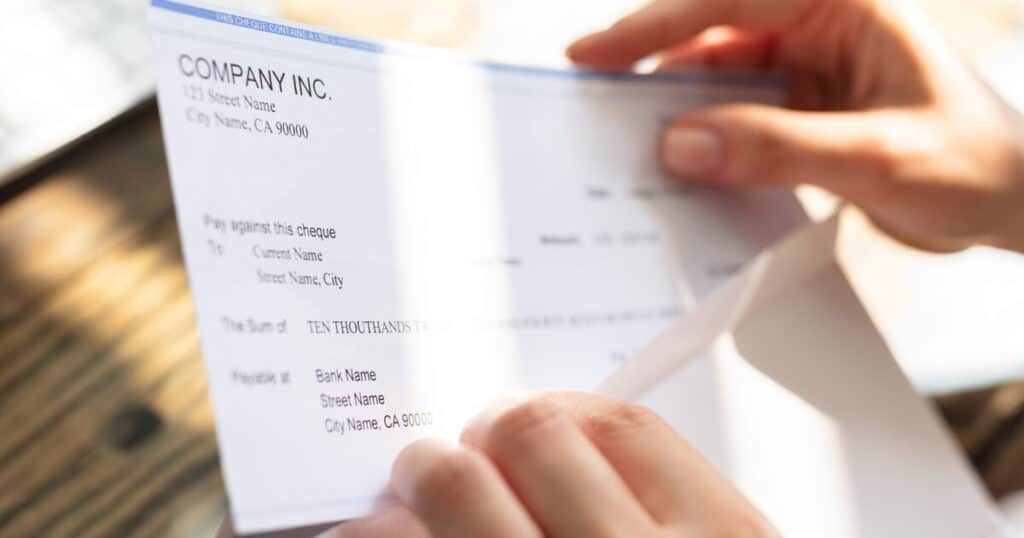 Worker is relieve to receive a workers' comp check after wondering, "if I get hurt at work do I get paid?"