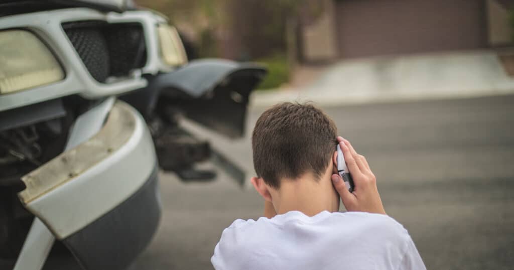 A young driver is on the phone with 911 as he tries to determine what to do after a car accident in Virginia.