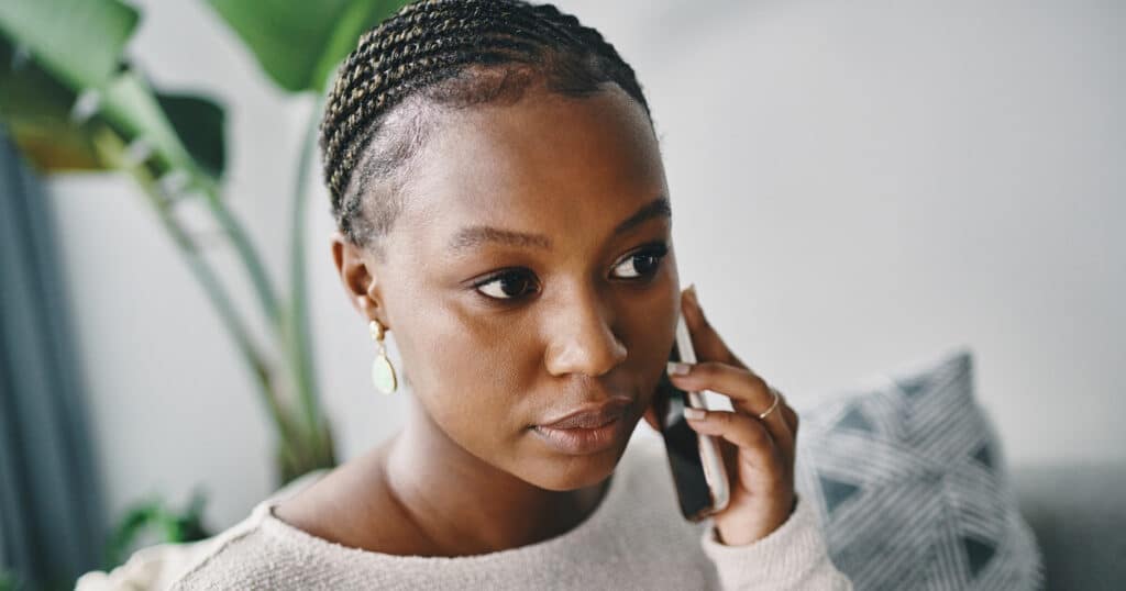 A woman is on the phone with an insurance company adjuster after witnessing a car accident.