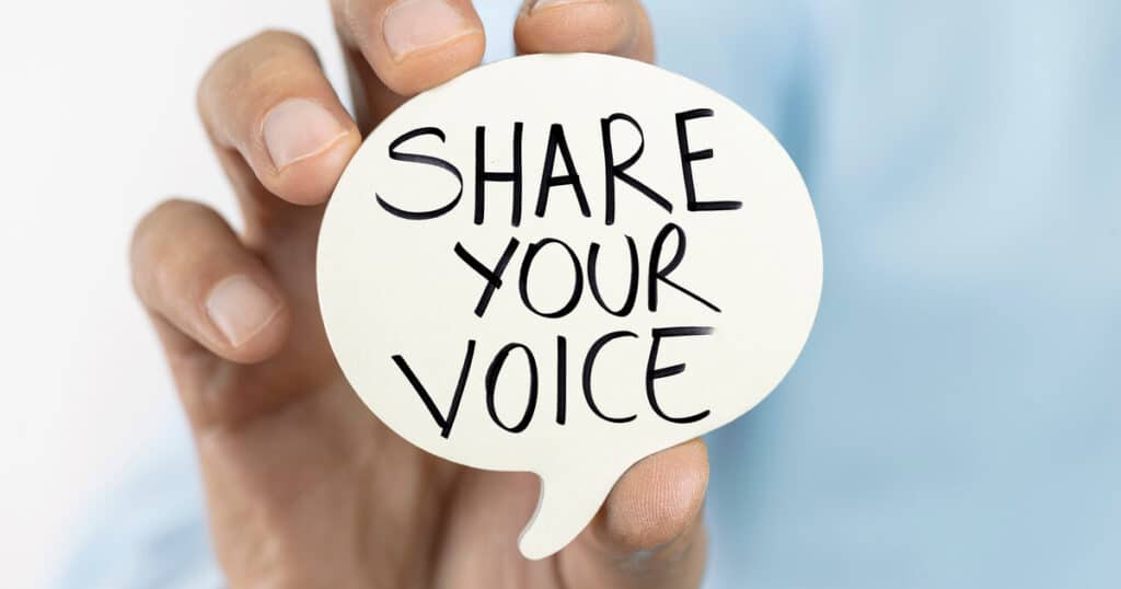 A person holding a speech bubble that says "share your voice" reminds us of the importance of advocating for state opt-in into the federal scholarship tax credit program.