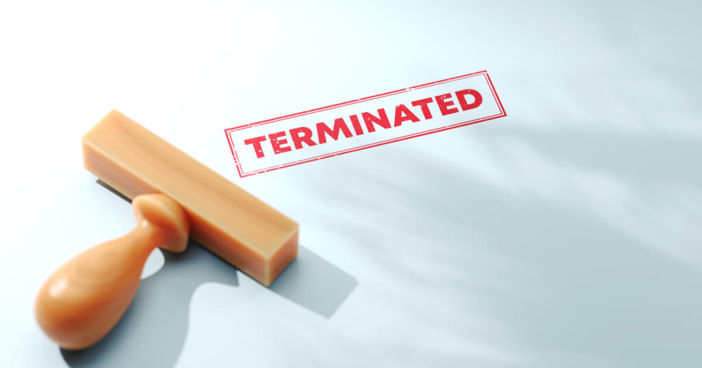 Has your job been terminated, as indicated by the stamp in this picture? If you are fired after a workers' comp settlement and suspect retaliation, talk to a lawyer.
