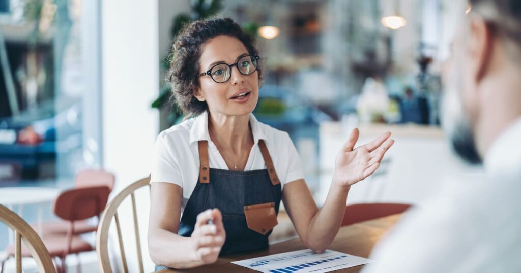 A female business owner speaks to a colleague about llc tax california and is wondering if those taxes apply to her.