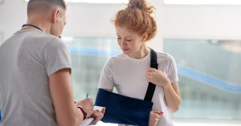 A female employee with a broken arm is thankful she went to the doctor after asking, "how does workers comp work for remote employees?"