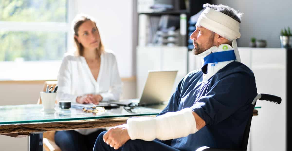 An injured worker in a wheelchair asks his workers comp lawyer, "Can you get workers comp and disability?"