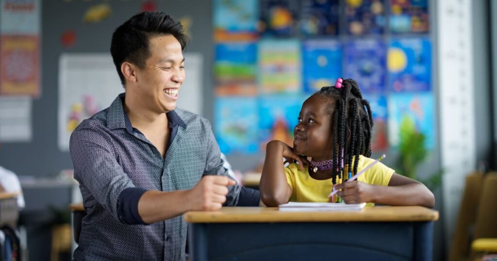 A man tutors a student who is a recipient of an education scholarship provided by a scholarship granting organization.